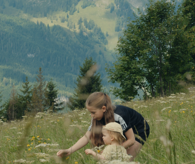 Children picking flowers in the alps