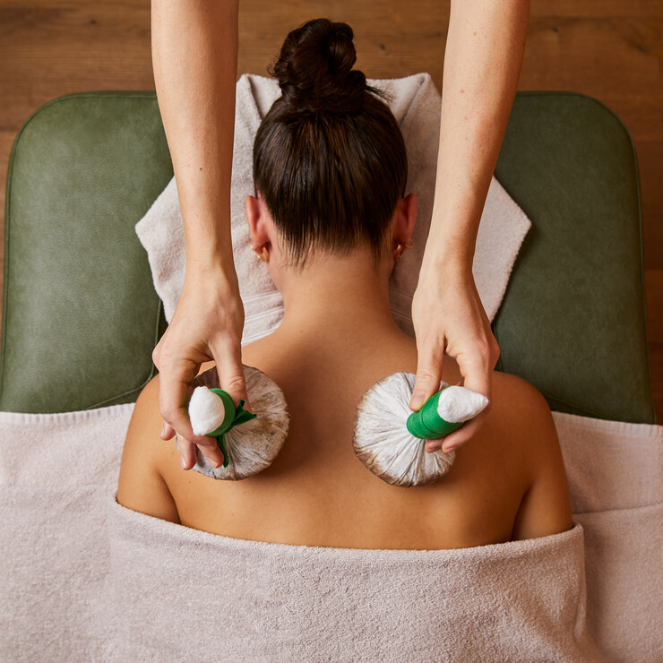 Wellness de luxe im Hotel Nesslerhof - Junge Dame bei einer Stempelmassage im Spa.