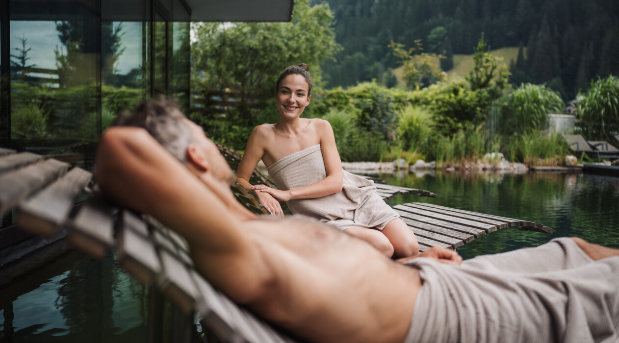 Couple is enjoing the sauna with view in the nature