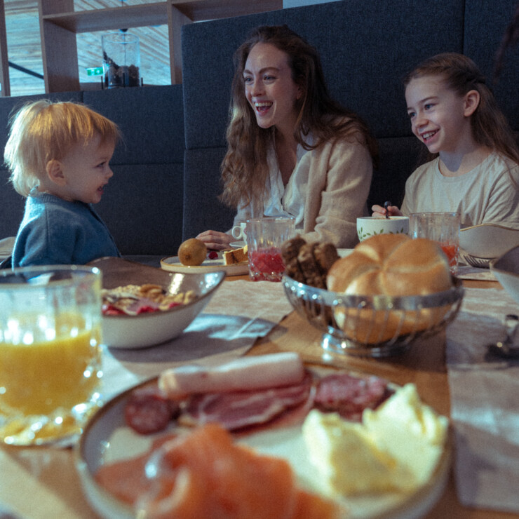 Young family is enjoying breakfast